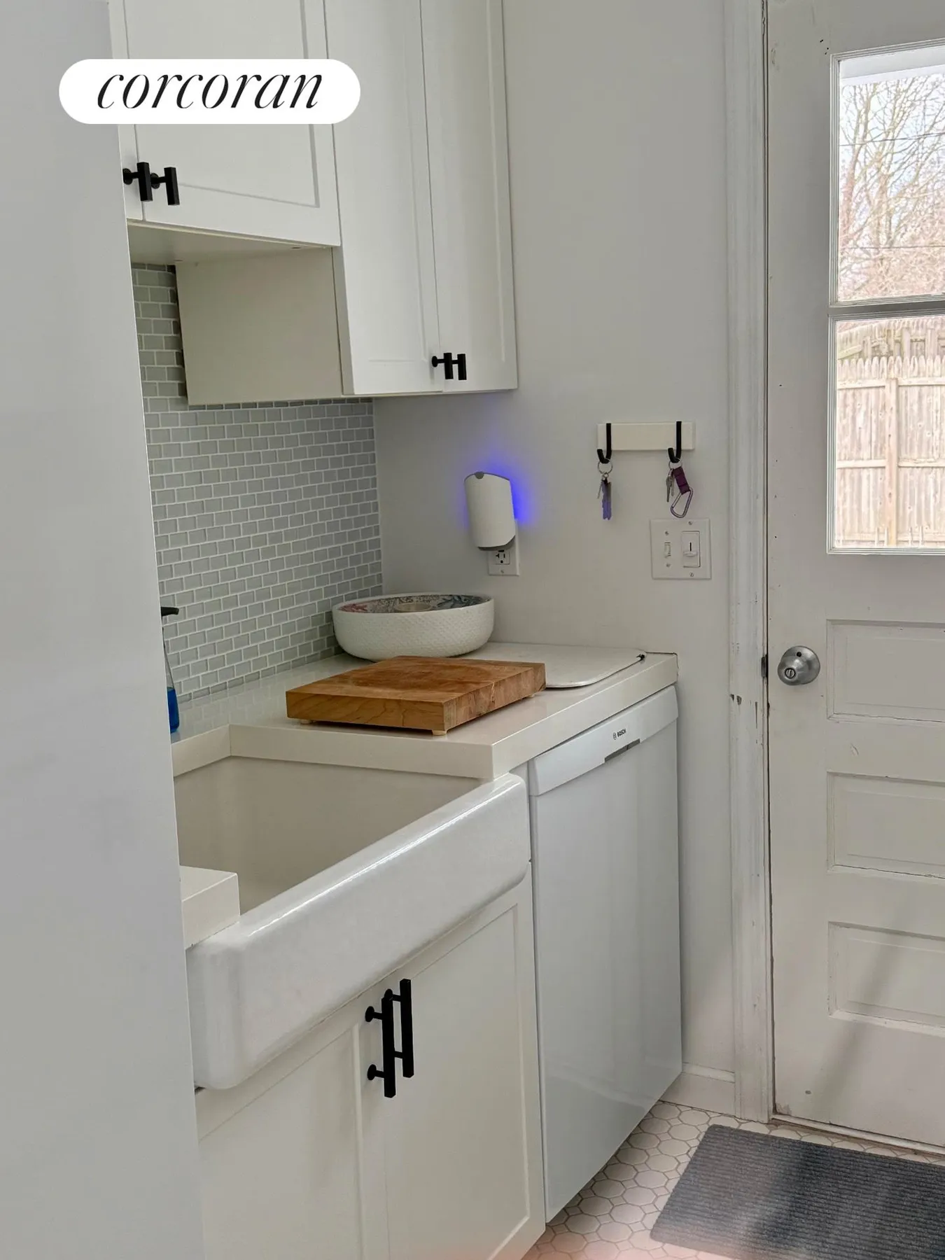 Laundry room with new washer and dryer, cabinets, and glass tile backsplash